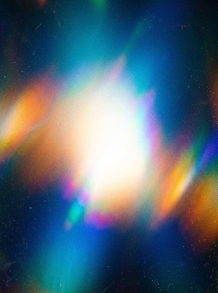 abstract luminous gradient, bright white central glow fading into deep blue and cyan, warm yellow and orange light leaks, heavy film grain texture, holographic color bleed, soft diffused lighting